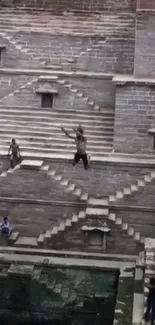 Stepwell in India with diver jumping.