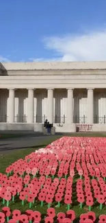 Wallpaper of a historic memorial with red flowers.