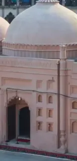 Beige dome mosque architecture with intricate design.