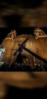 Historic church facade at night with silhouette and intricate details.