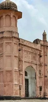 Historic pink building with sky in background.