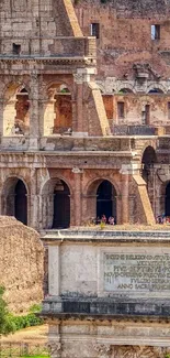 Close-up of the Roman Colosseum exterior in sunlight.