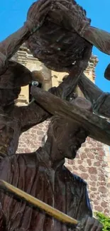 Bronze statue with a blue sky backdrop.