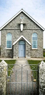 Historic stone chapel in rural landscape wallpaper.
