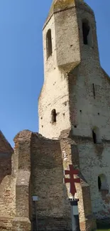 Ancient brick tower under a clear blue sky.