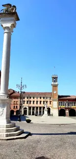 Historic city square with a tall stone column under a clear blue sky.