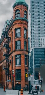 Red-brick building amid a modern cityscape, showcasing historic urban architecture.