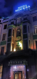 Historic hotel facade illuminated at night.