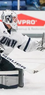 Hockey goalie making a dynamic save on the ice rink.