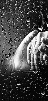 Hands held amidst falling raindrops on a dark background.