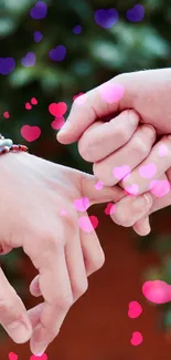 Two hands with colorful bracelets in a handshake against a natural background.