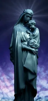 Sculpture of Virgin Mary with child under a starry purple sky.