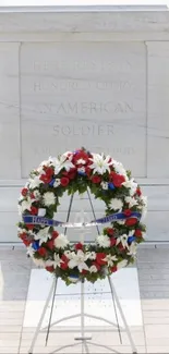 Honor guard at memorial with wreath and tomb.