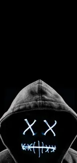Hooded figure with neon mask on a black background.