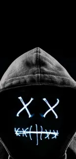 Dark hooded mask with glowing accents on black background.