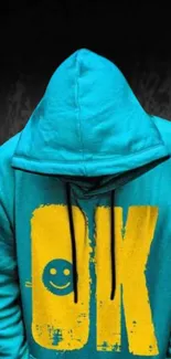 Turquoise hoodie artwork with bold 'OK' design on dark background.