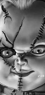 Black and white creepy horror doll wallpaper with stitched face.