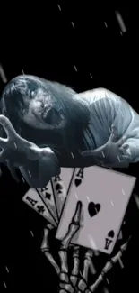 Horror themed wallpaper with skeleton hand and playing cards.