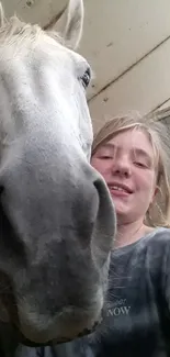 Girl taking a selfie with a horse in an endearing close-up shot.