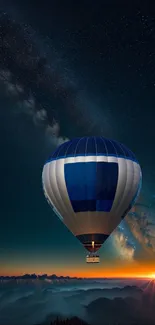 Hot air balloon floating under a starry sky with a vibrant sunset on the horizon.