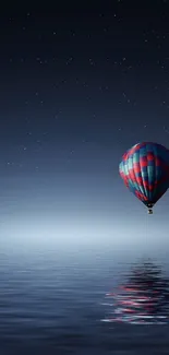 Serene hot air balloon floating over reflective night water, under a starry sky.