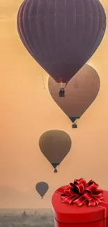 Hot air balloons float gracefully over a sunrise-lit landscape.