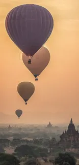 Hot air balloons float over temples at sunrise, creating a serene landscape.