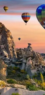 Colorful hot air balloons over Cappadocia at sunrise.