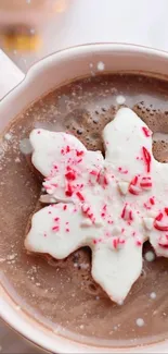 Hot cocoa in mug with snowflake cookie topping.