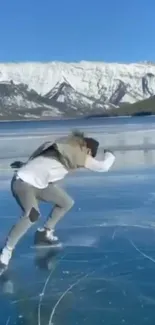 Person ice skating on a clear frozen lake with snowy mountains.