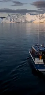 Boat sailing near majestic icebergs at sunset.