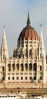 Mobile wallpaper of iconic parliament building by a river with blue sky.