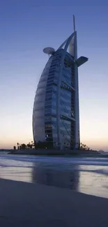 Burj Al Arab at sunset with ocean reflections.