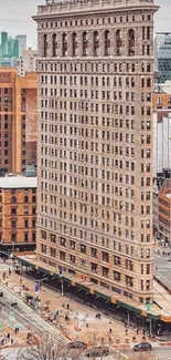 Flatiron Building in New York City with urban backdrop.