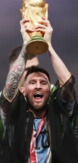 Football icon celebrates with trophy held high.