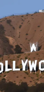 Mobile wallpaper with iconic Hollywood Sign on brown hillside.