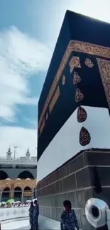 Kaaba in Makkah under clear blue sky.