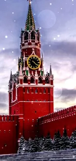 Spasskaya Tower of the Kremlin in winter with snowy landscape.