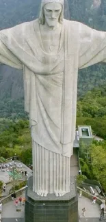 Christ the Redeemer statue amid lush greenery.