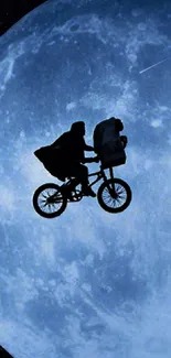 Silhouette of a bike flying across a large blue moon.