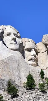 Mount Rushmore with blue sky background.