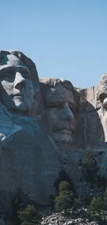 Mount Rushmore with clear blue sky and stone-carved presidents.