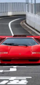 Iconic red sports car on empty road.