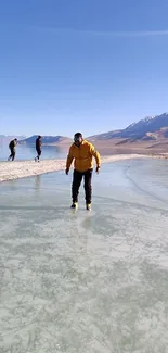 Person ice-skating on a frozen lake with mountains in the background.