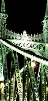 Illuminated bridge at night with intricate details.