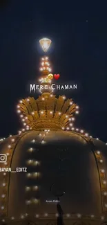 Illuminated dome at night with lights and deep blue sky.