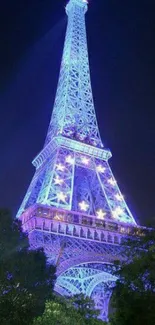 Eiffel Tower illuminated in blue at night, Paris.