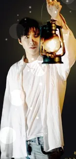 Person holding a lantern against a dark background.