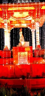 Illuminated monument with vibrant orange lights at night.