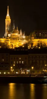 Golden cityscape at night with reflections on water.